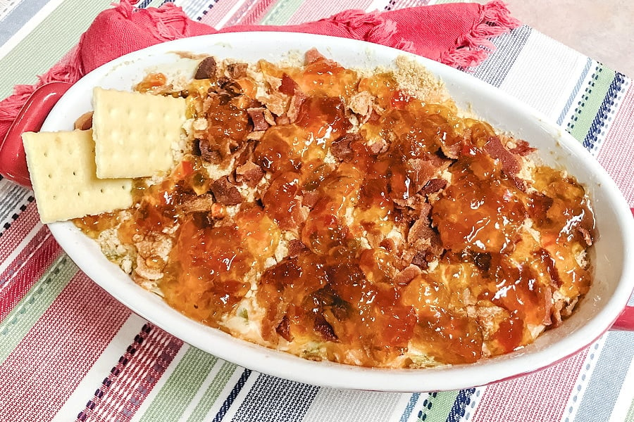 A casserole dish loaded with air fryer pepper jelly cheese dip.