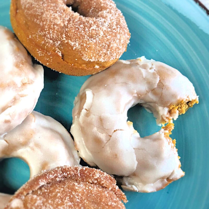 Oven baked pumpkin doughnuts on a plate.