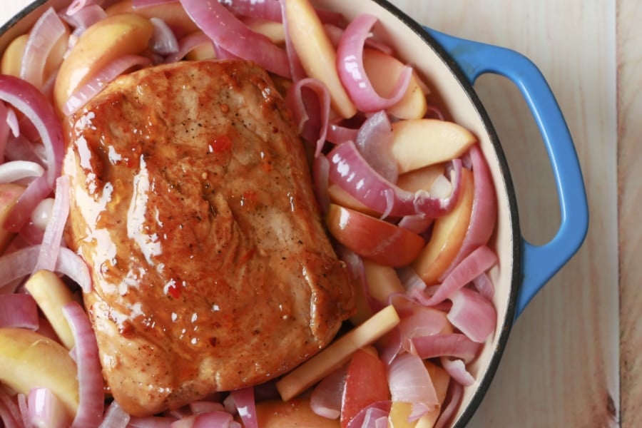 Pepper Jelly Glazed Pork Loin Roast in a blue cast iron skillet.