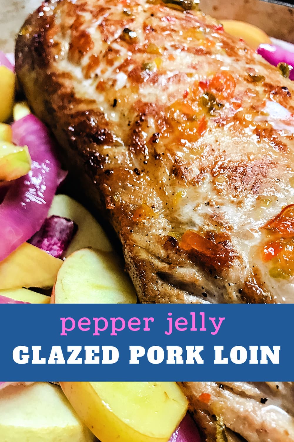 A large glazed pork loin nestled in a bed of sliced apples and sliced red onions. 