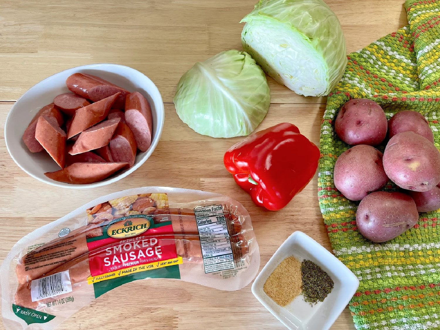 All the ingredients needed to make Sausage, Potato, and Cabbage Sheet Pan Meal. 