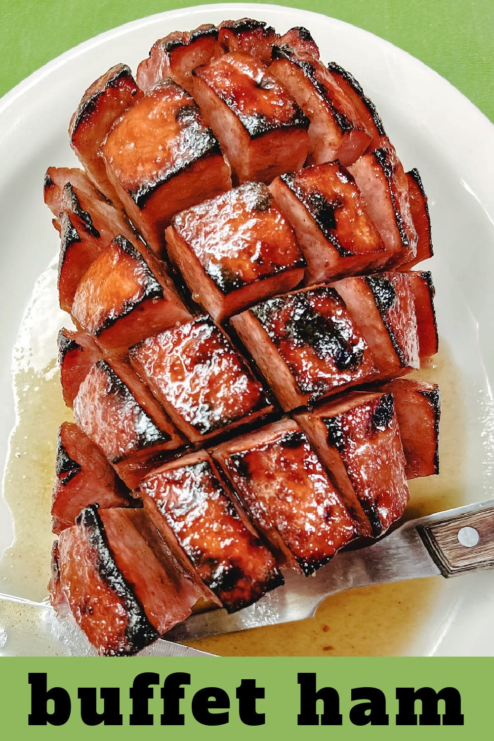 a baked, boneless buffet ham with glaze on a white platter. 