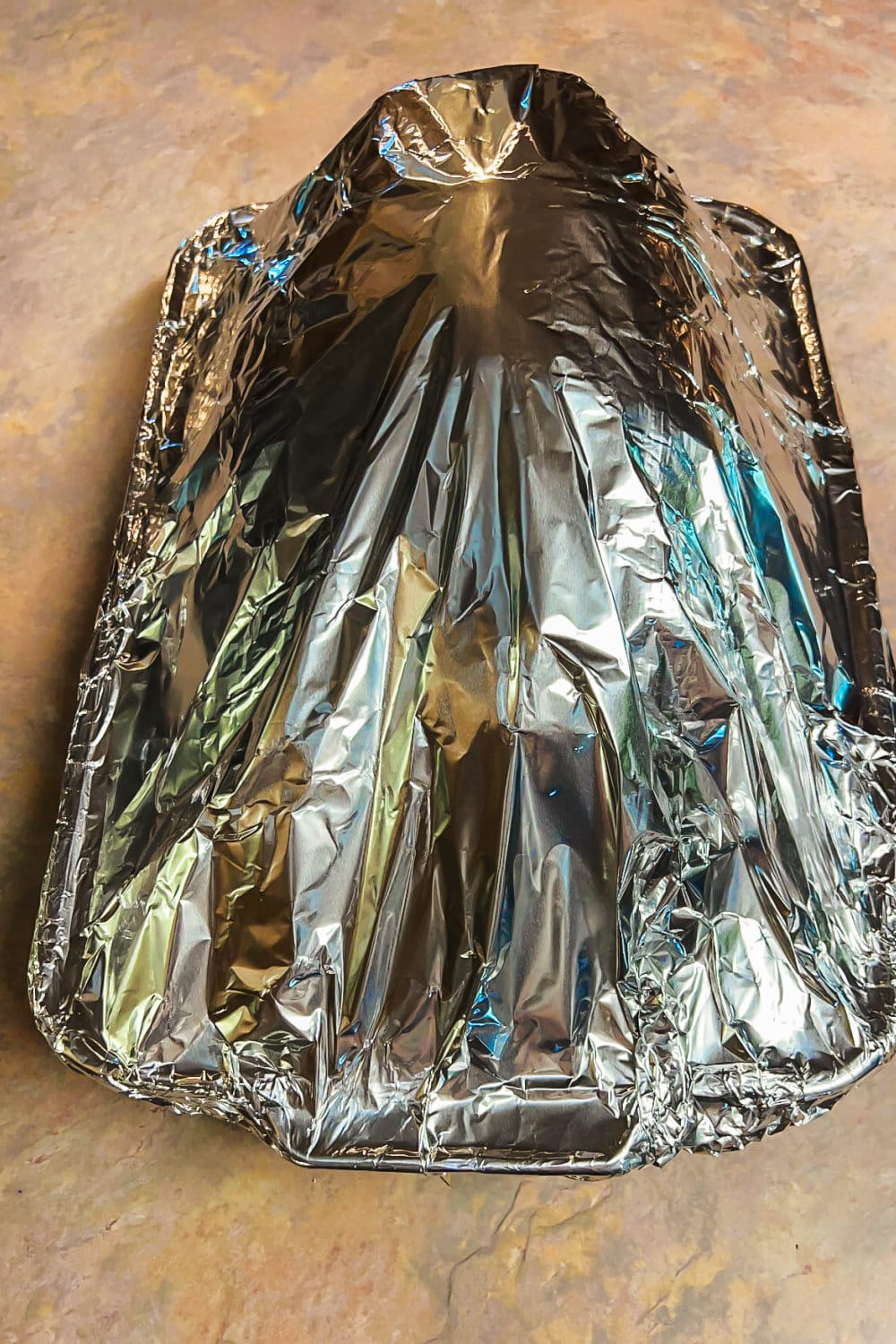 Ham covered with foil, ready for the oven. 