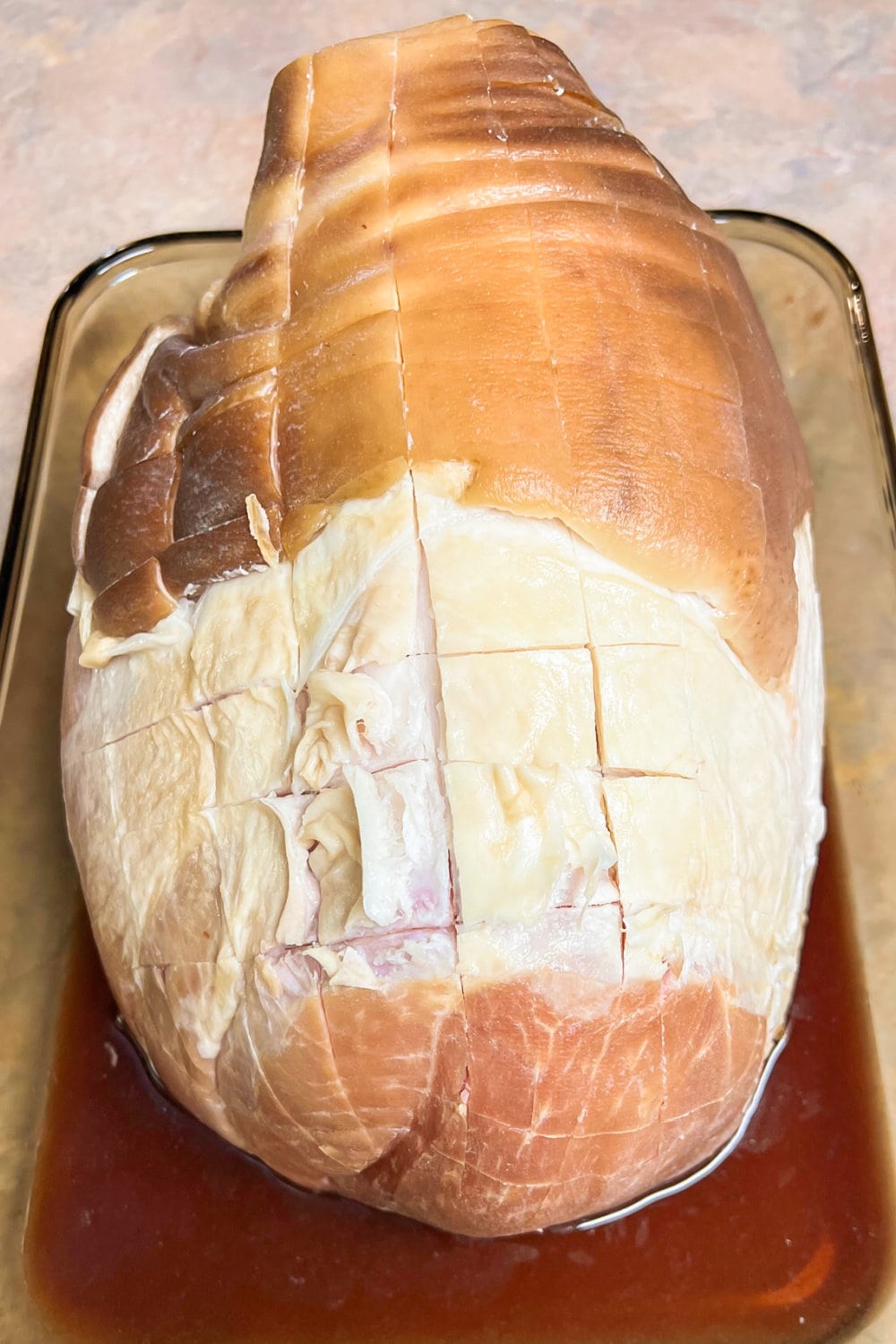 Bone-in ham that's been scored and ready to bake. 