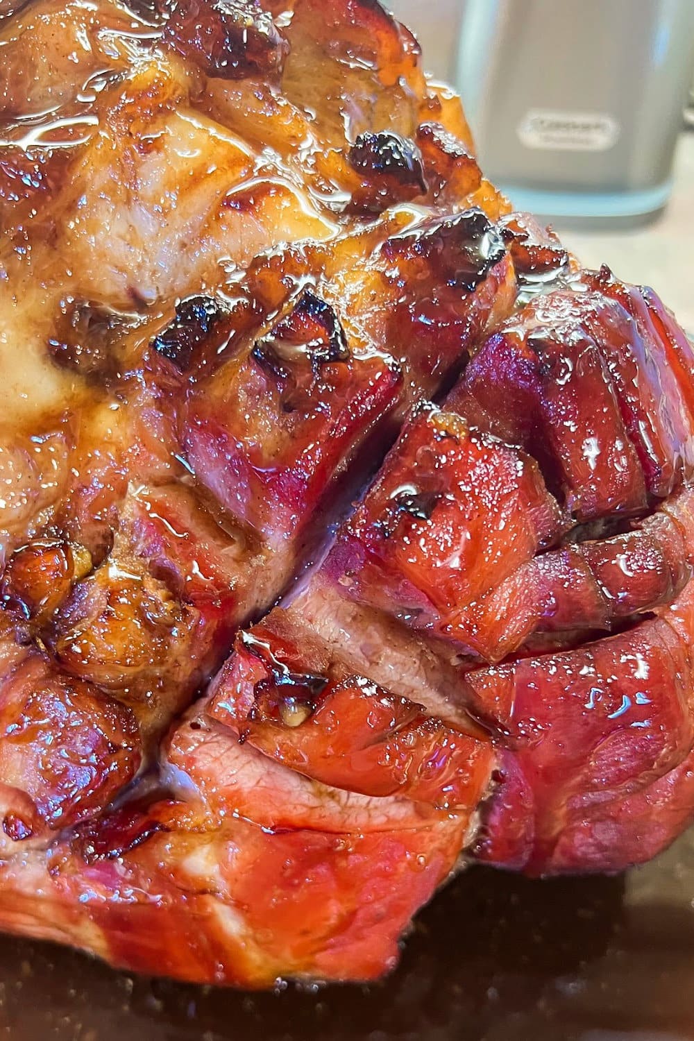 Glazed sticky ham, hot from the oven and ready to be sliced to serve. 