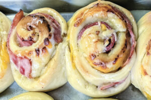 Warm Farm House Ham and Cheese Rolls on a baking sheet.