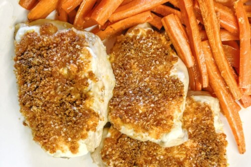 Crispy Parmesan Chicken Breasts paired with roasted carrots.