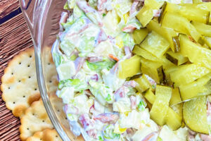 Italian Hoagie Dip topped with chopped pickles, ready to serve.