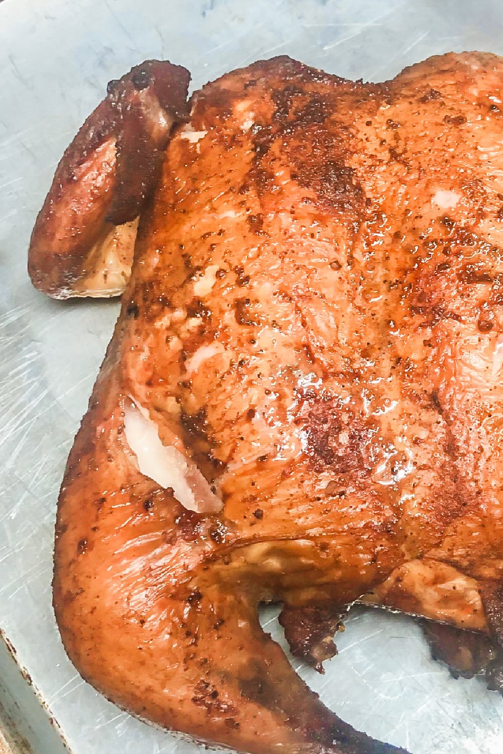 A whole smoked chicken, all seasoned and golden brown. 