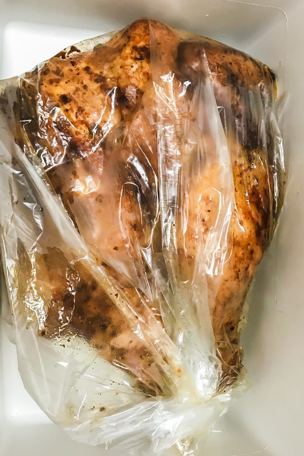 Smoked chicken in an oven bag resting and steaming. 