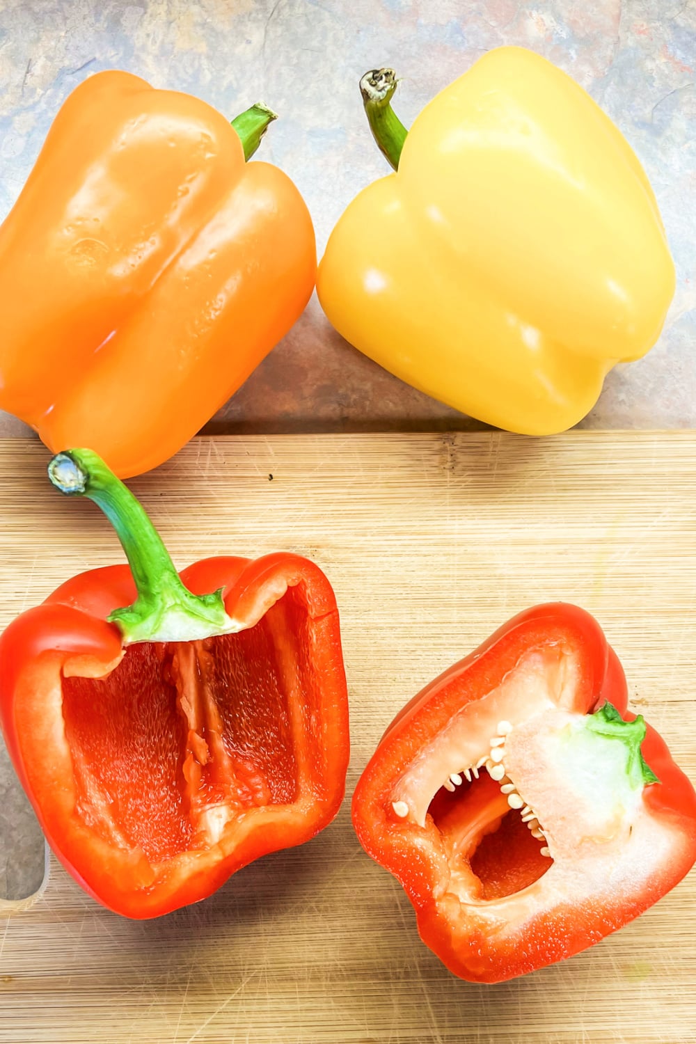 Bell peppers sliced in half to reveal the seeds and membranes. 