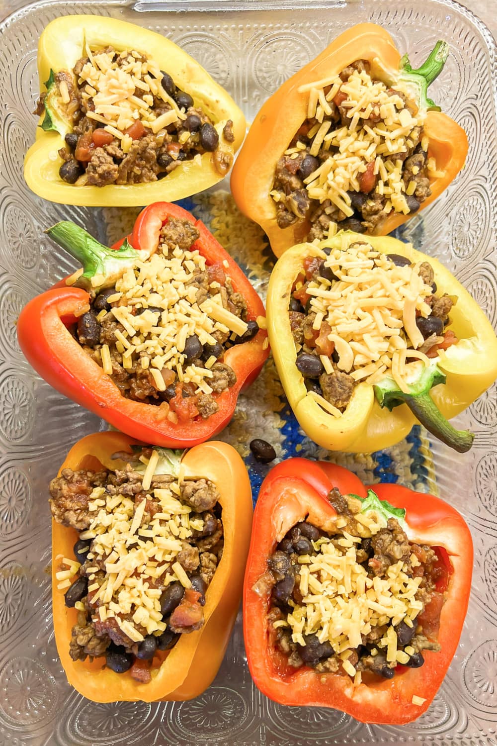 Stuffed bell peppers sprinkled with cheese. 