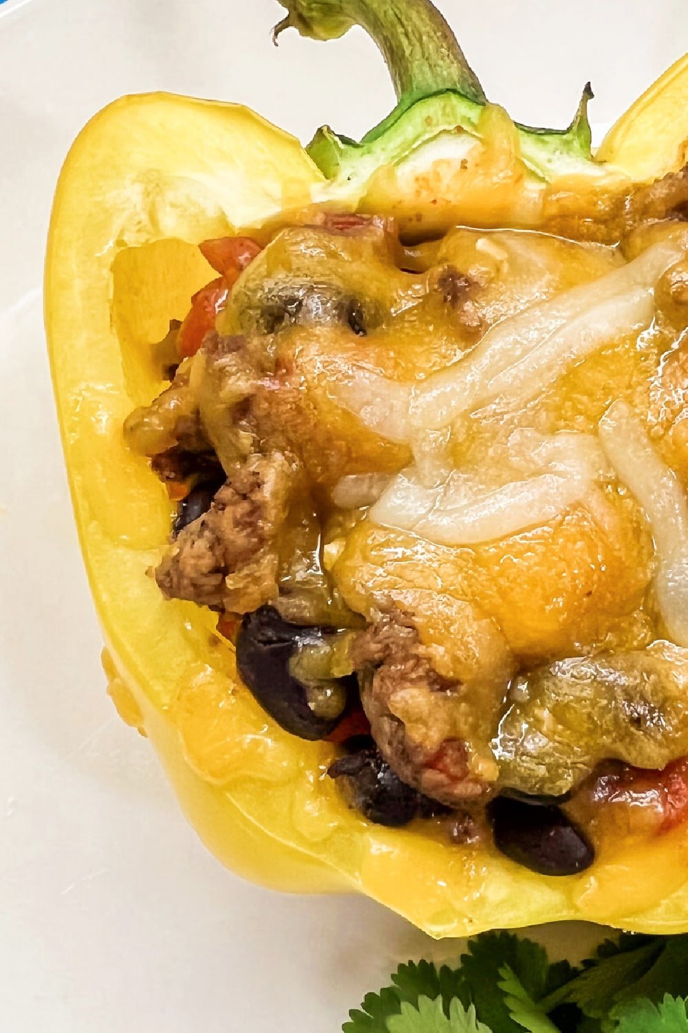 A yellow bell pepper loaded with taco meat. 