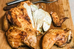 Smoked Spatchcock Chicken on cutting board.