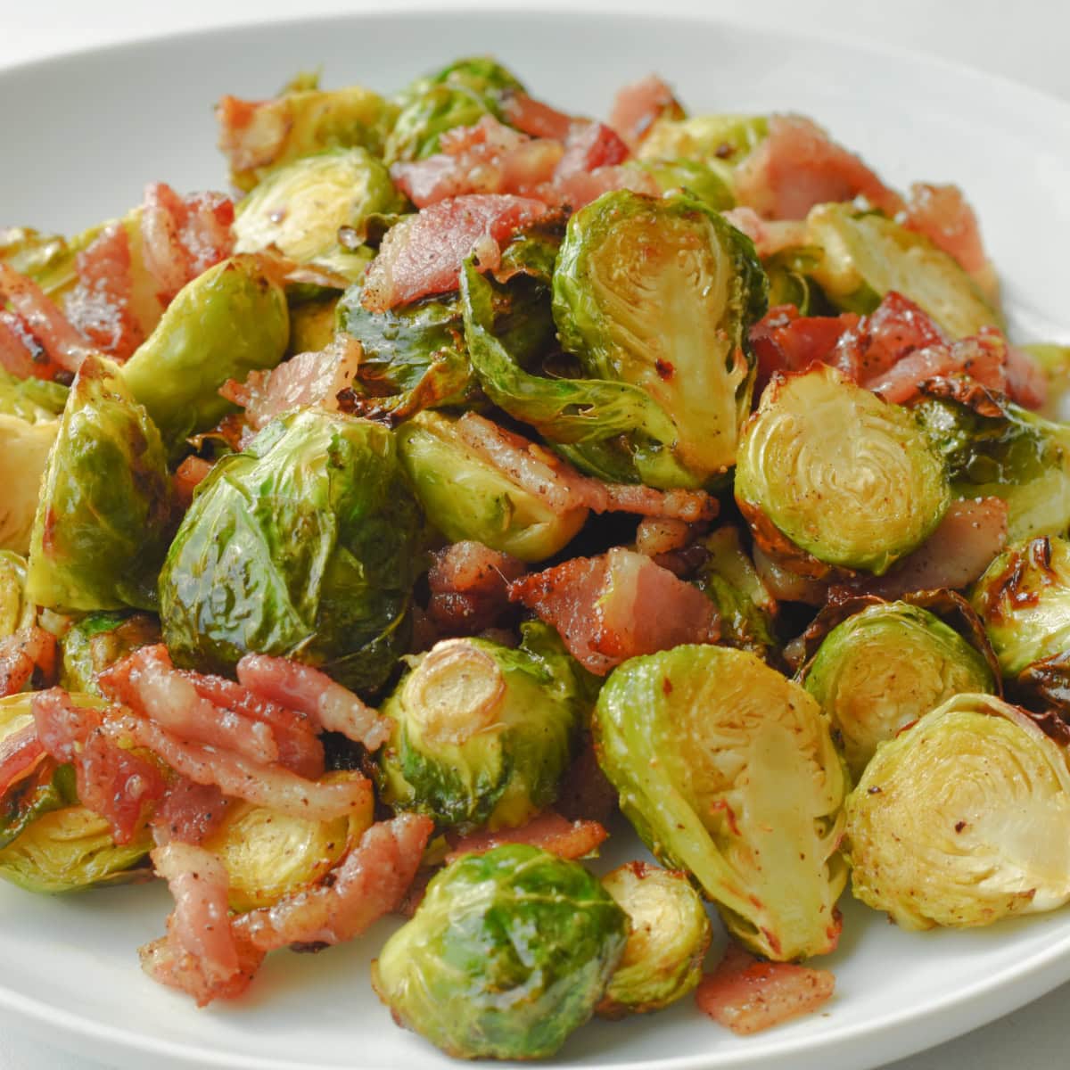 A large platter of Air Fryer Brussels Sprouts with chopped bacon.