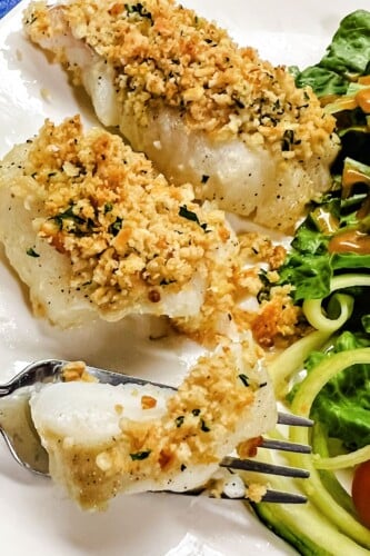 Butter Cracker Baked Cod Fillets on a white plate with a fork. 