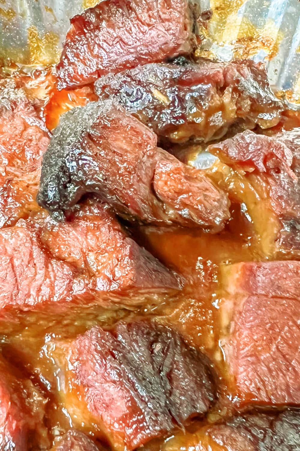 Beautiful fork-tender smoked burnt ends with a sauce. 