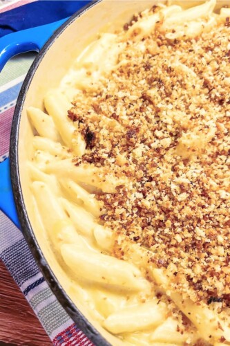 A loaded skillet full of creamy mac and cheese with crumb topping. 