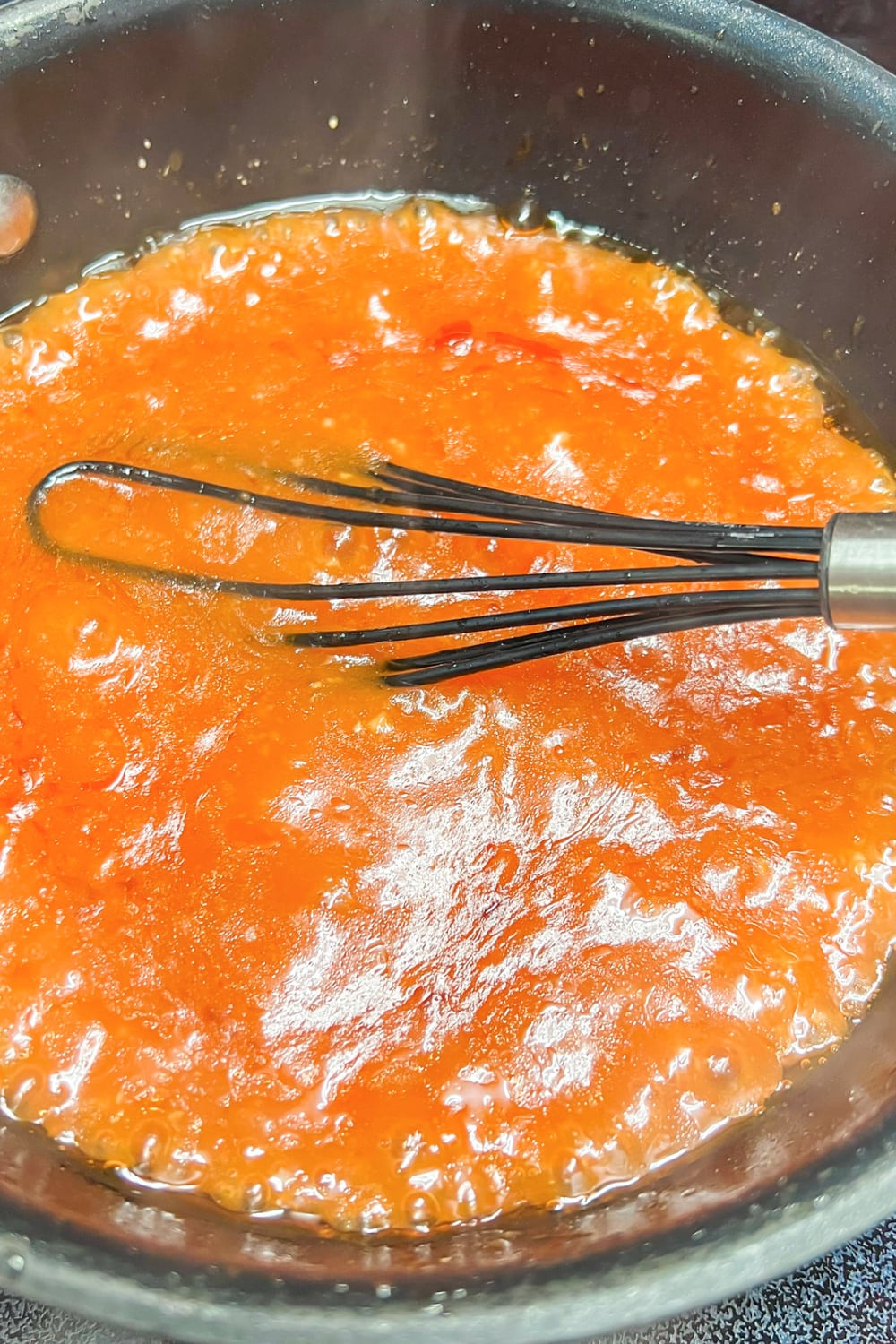Sweet and sour sauce simmering in a saucepan. 