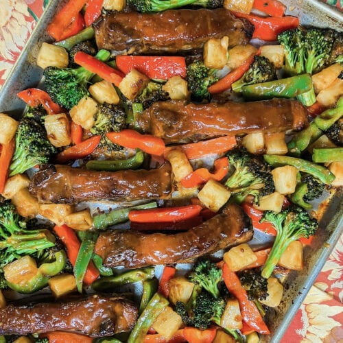 Boneless Pork Ribs with Sweet and Sour Sauce on a sheet pan with vegetables.