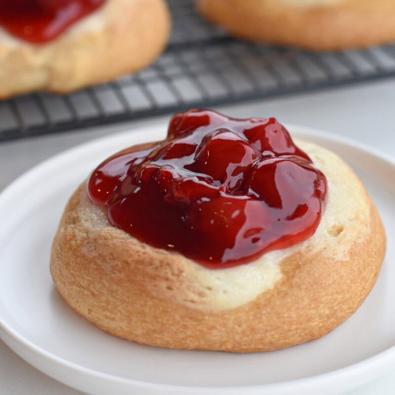 Cherry cream cheese danish on a white plate.