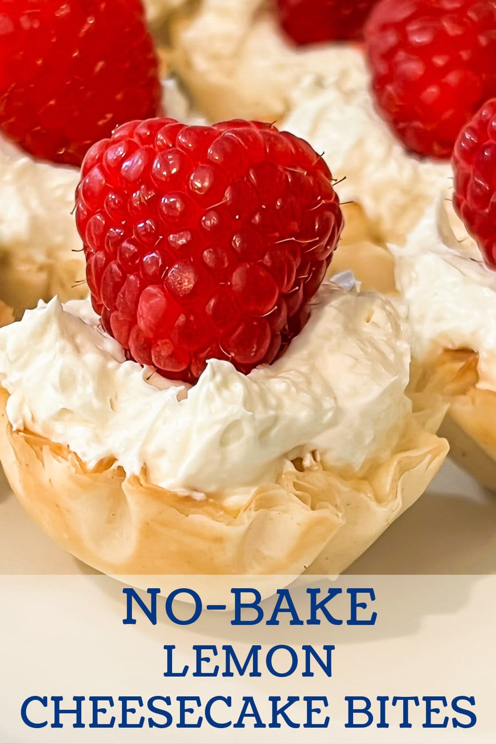 A No Bake Lemon Cheesecake Bite topped with a fresh raspberry. 