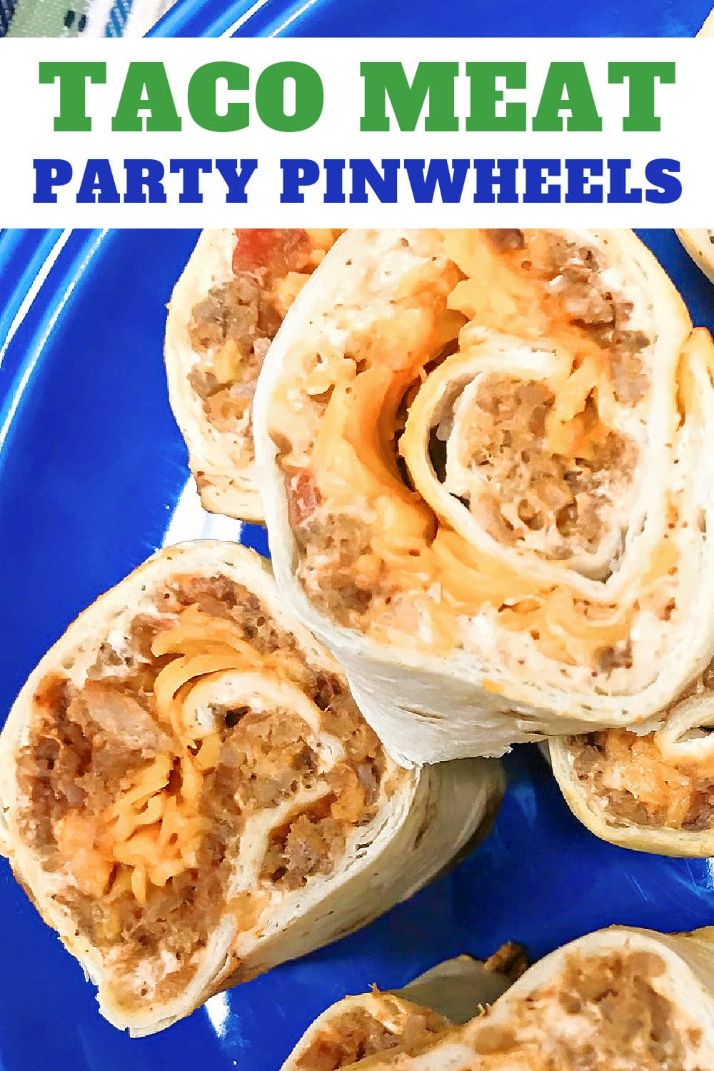 Meat and cheese pinwheels on a blue platter. 