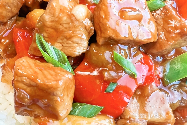 Chunks of pork with vegetables in a sweet and sour sauce.