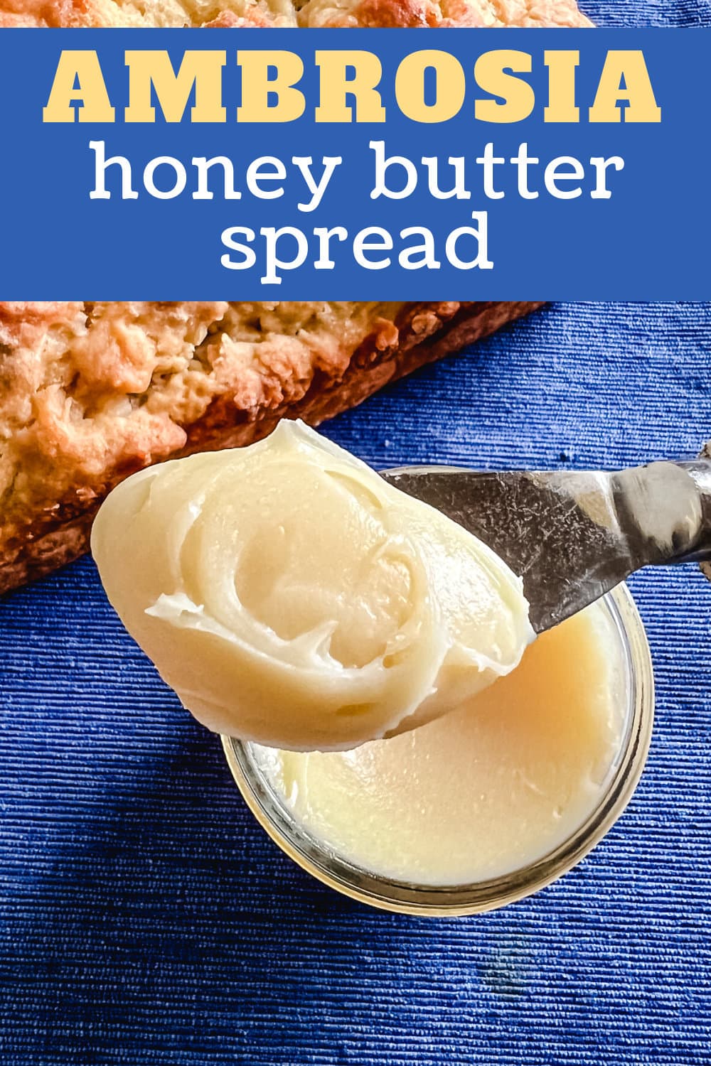 A spreader full of honey butter spread. 