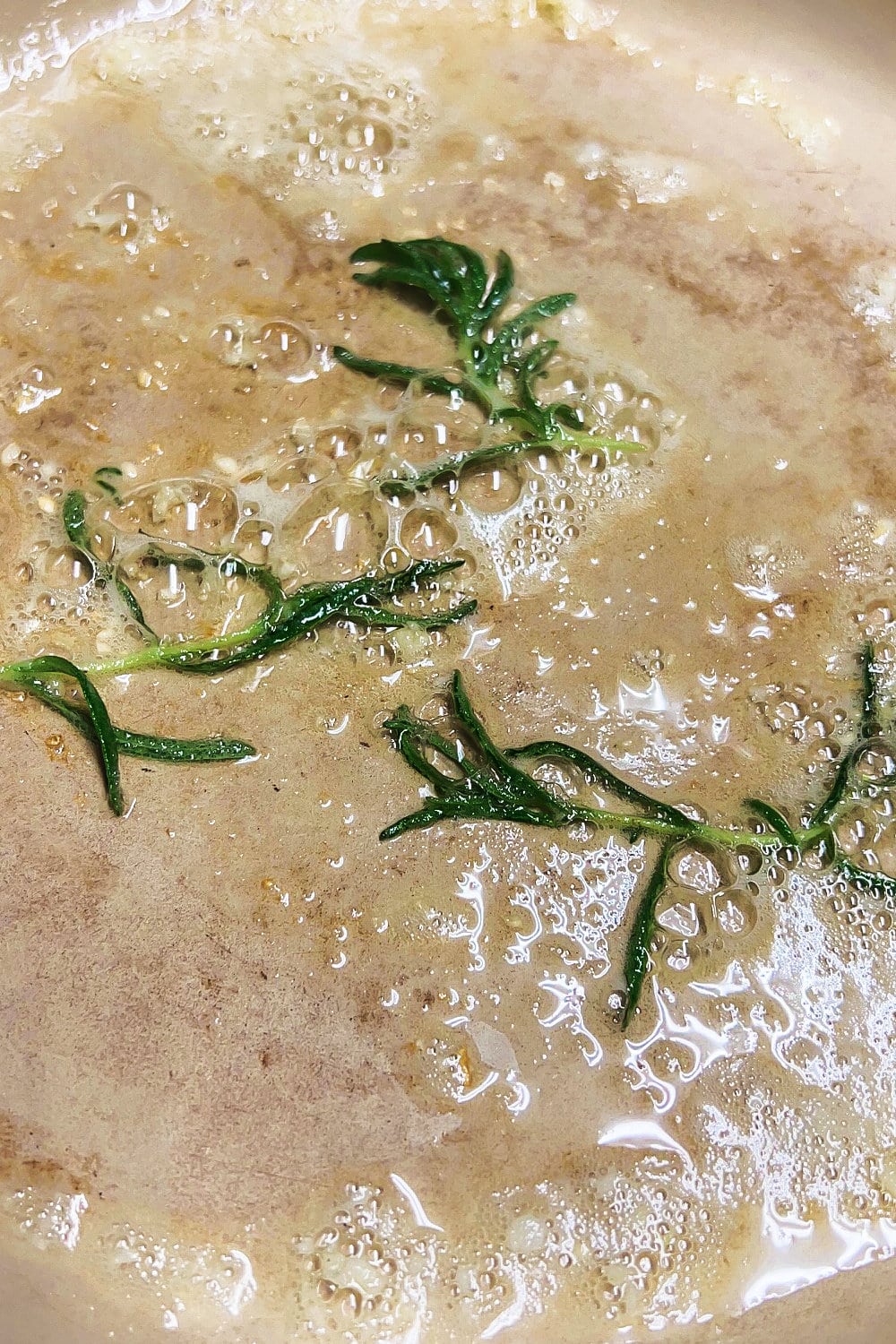 Garlic and rosemary sizzling a bit in melted butter. 