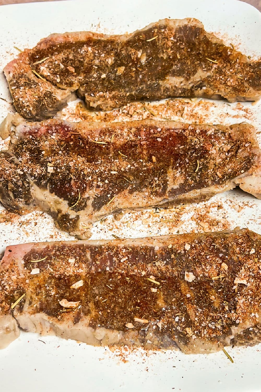 Seasoned steaks ready to be cooked.