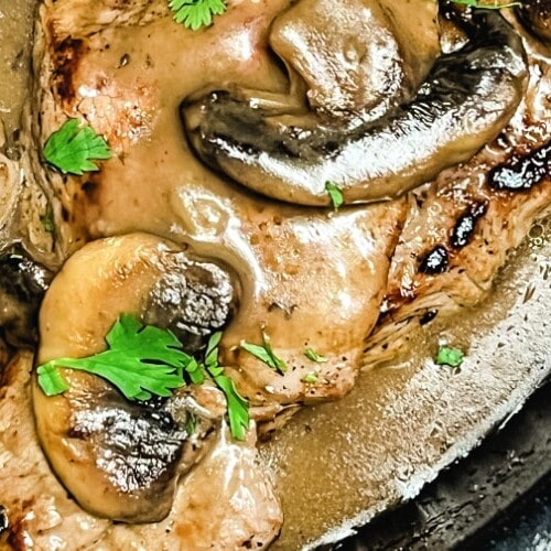 Sizzle Steaks nestled in Mushroom Gravy in a skillet.