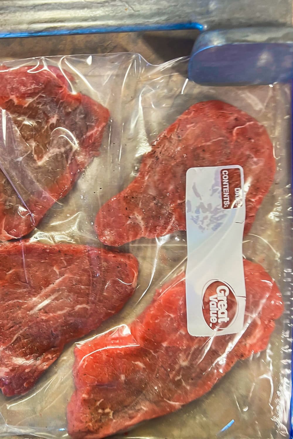 Steaks in a gallon bag that have been pounded with a meat mallet. 