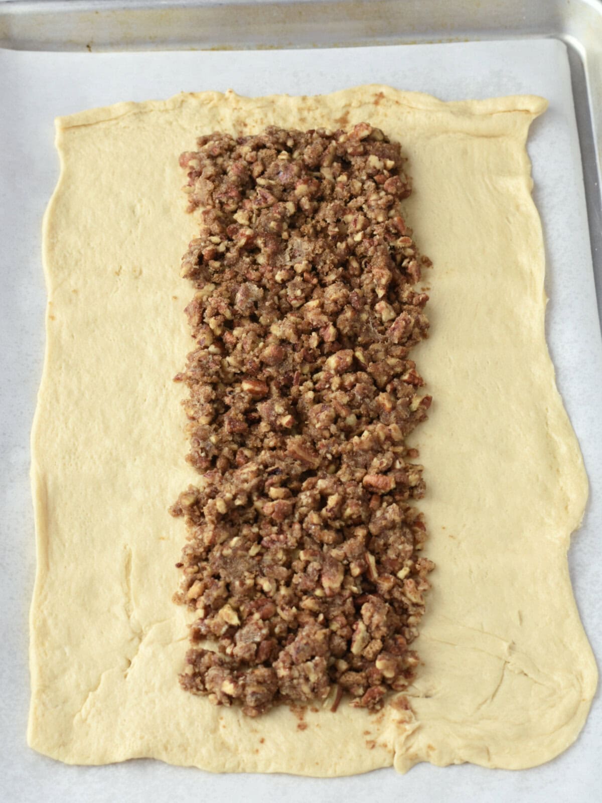 A picture of the placing the filling into the roll. 