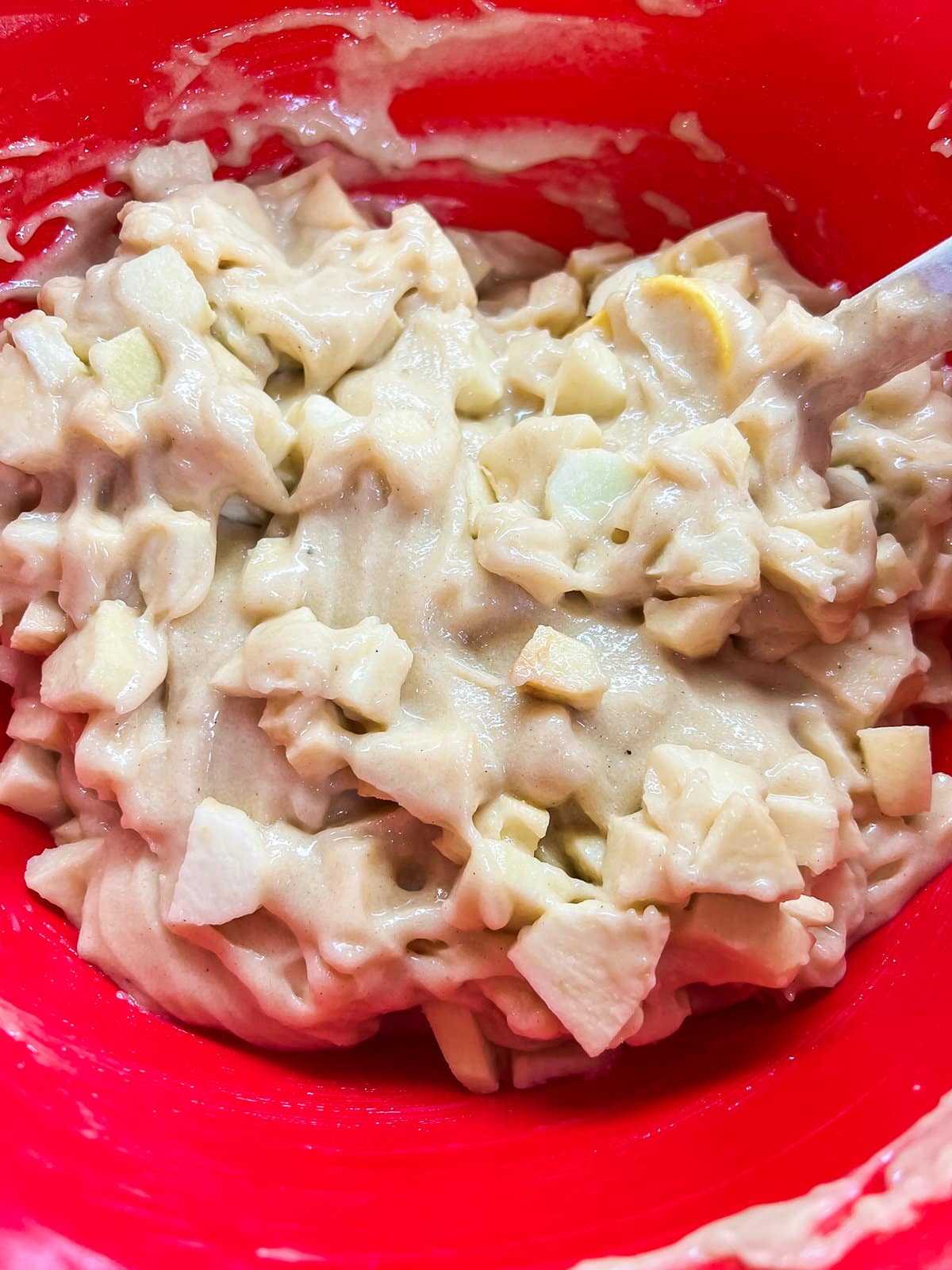 Chopped apples stirred into the apple cake batter. 