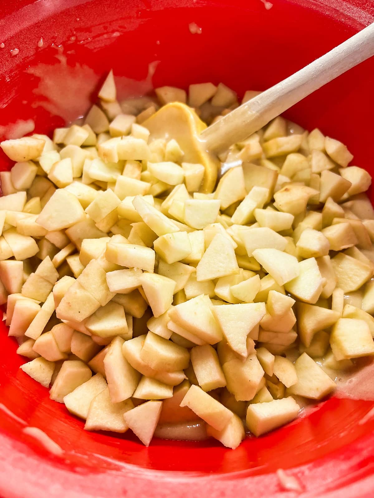 Chopped apples just added on top of the apple cake batter. 