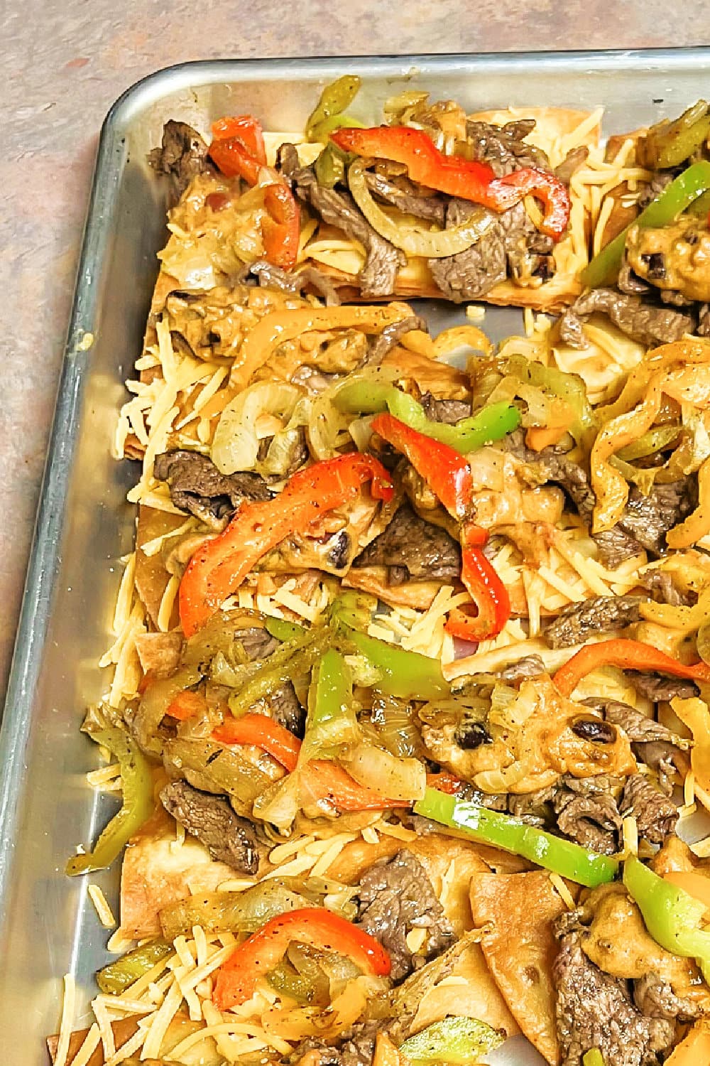 Sizzle Steak Nachos ready to be heated in the oven.