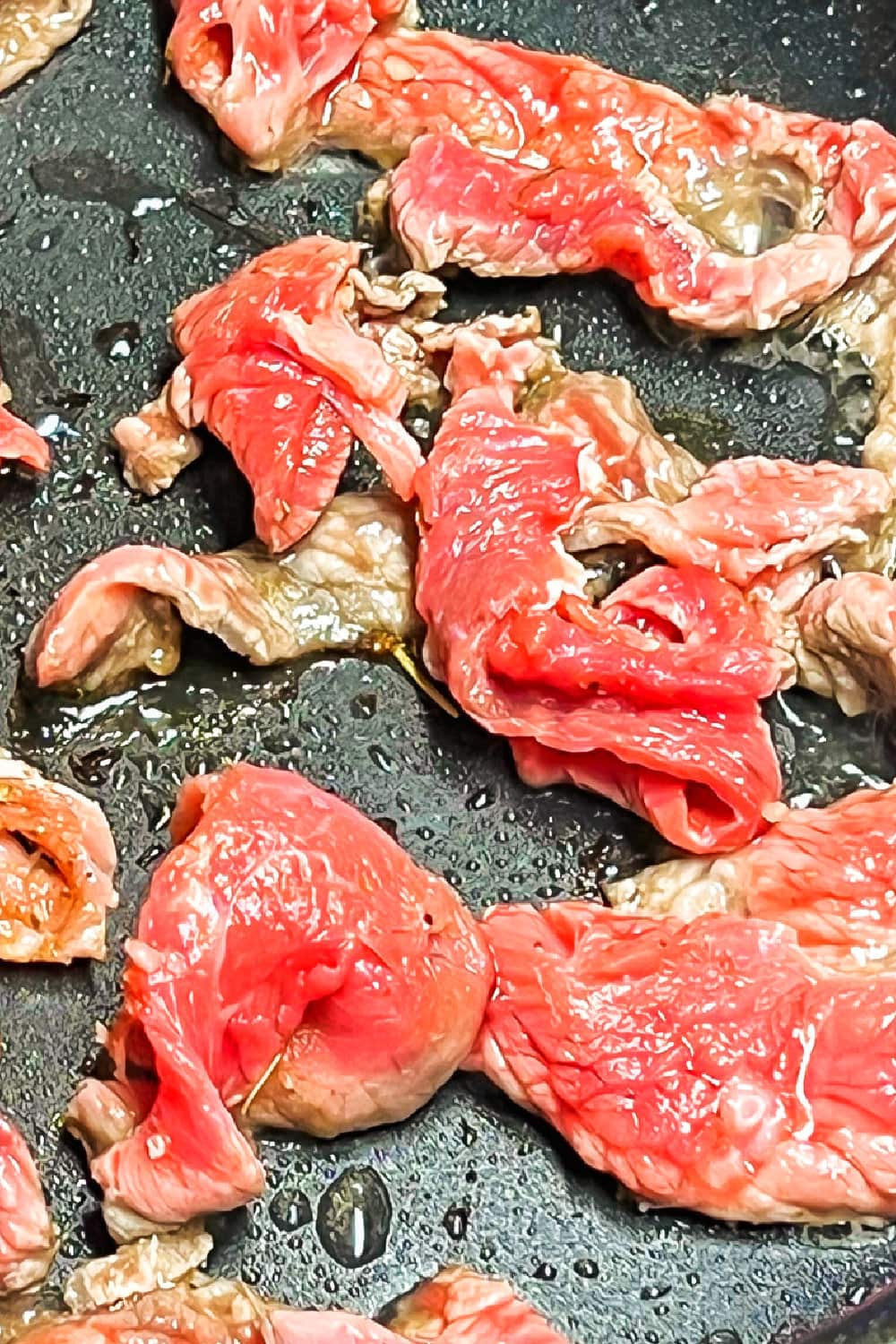 Sizzle steak searing in a hot skillet. 