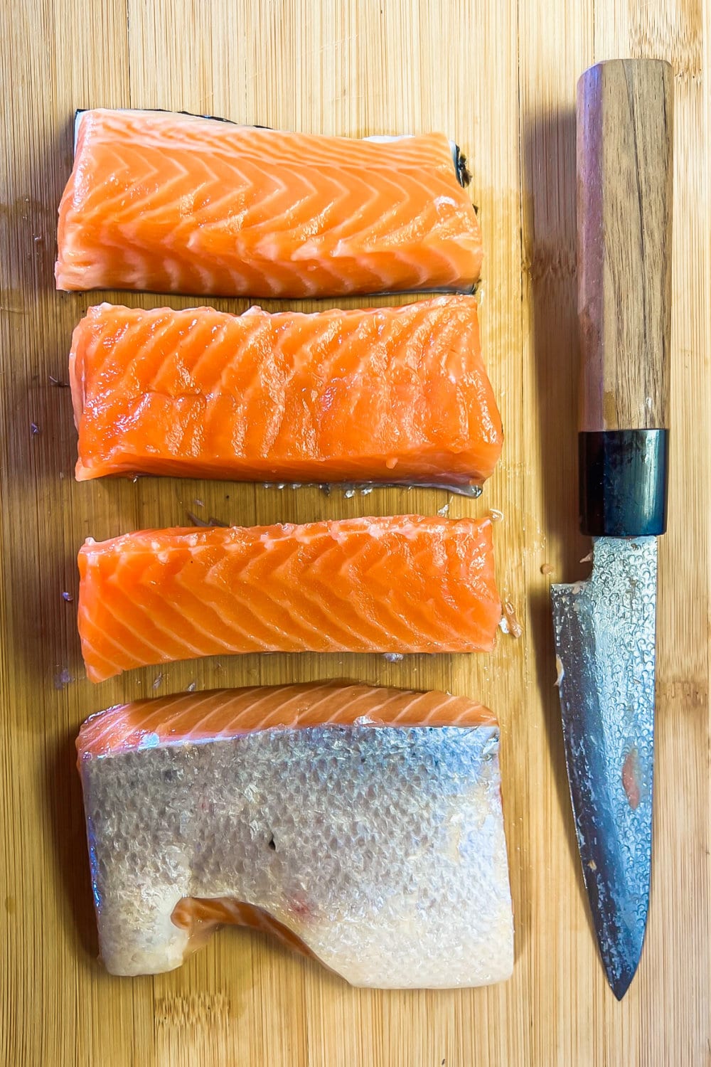 A fresh salmon fillet that has been cut into portions. 