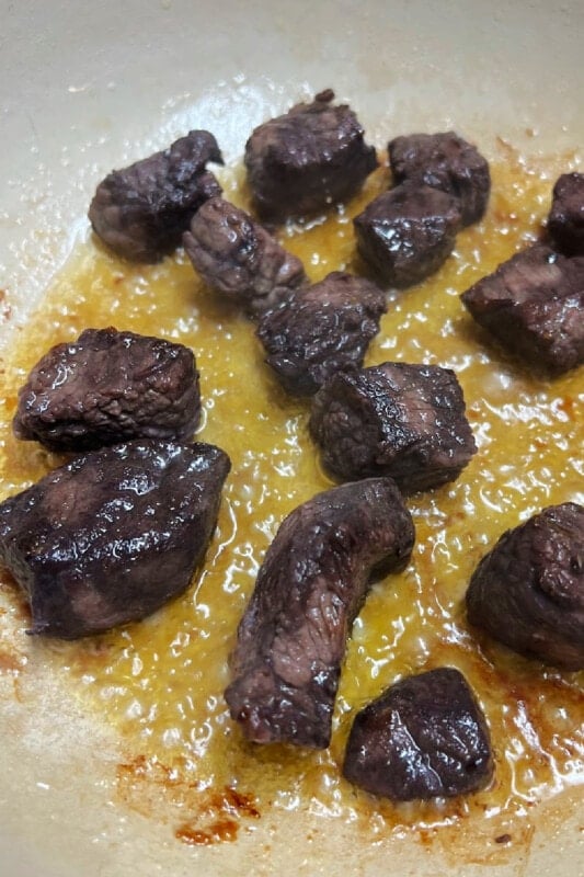 Beef stew meat browning in hot oil.