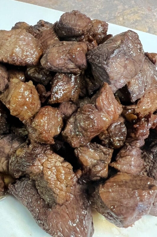 A pile of beef stew meat that has been browned in hot fat.