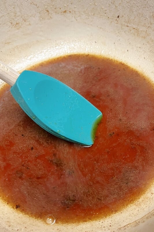 Deglazing the pan with a bit of broth.