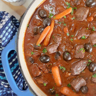 Hot and fresh, beef stew in a blue pot.