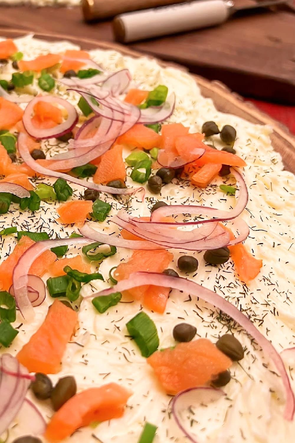 Smoked salmon with brie cheese and toppings for a butter board. 