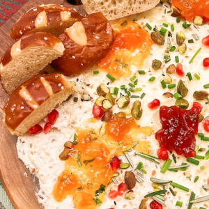 A butter board with jams and spreadable cheeses.