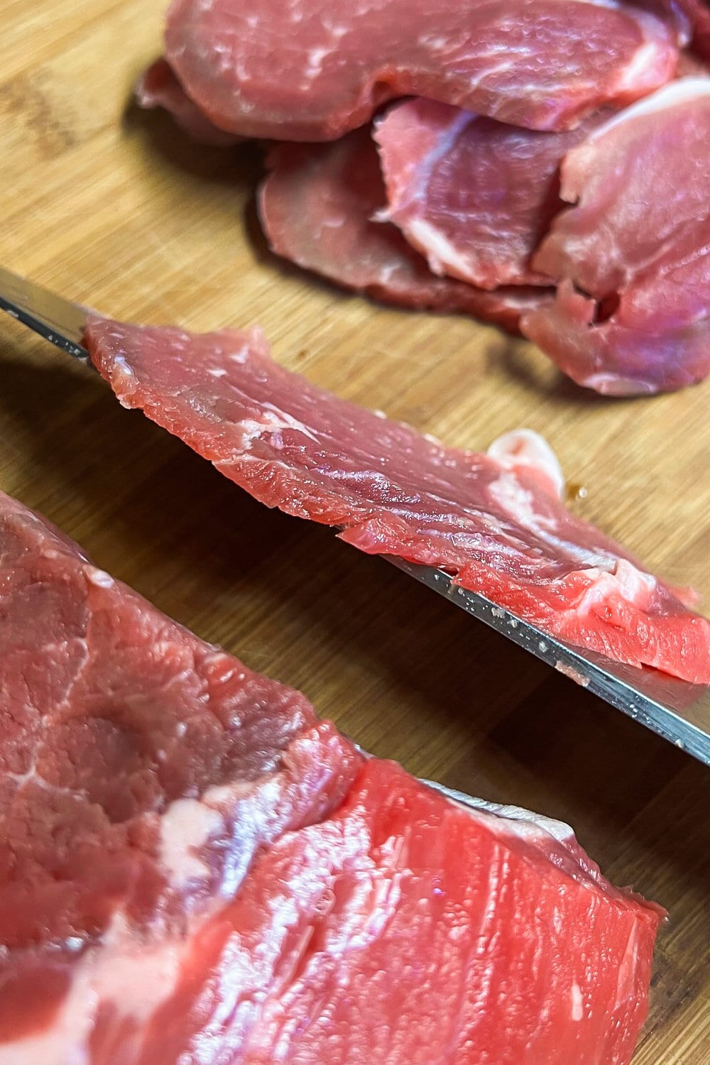 Slicing a sirloin tip roast into very thin slices. 