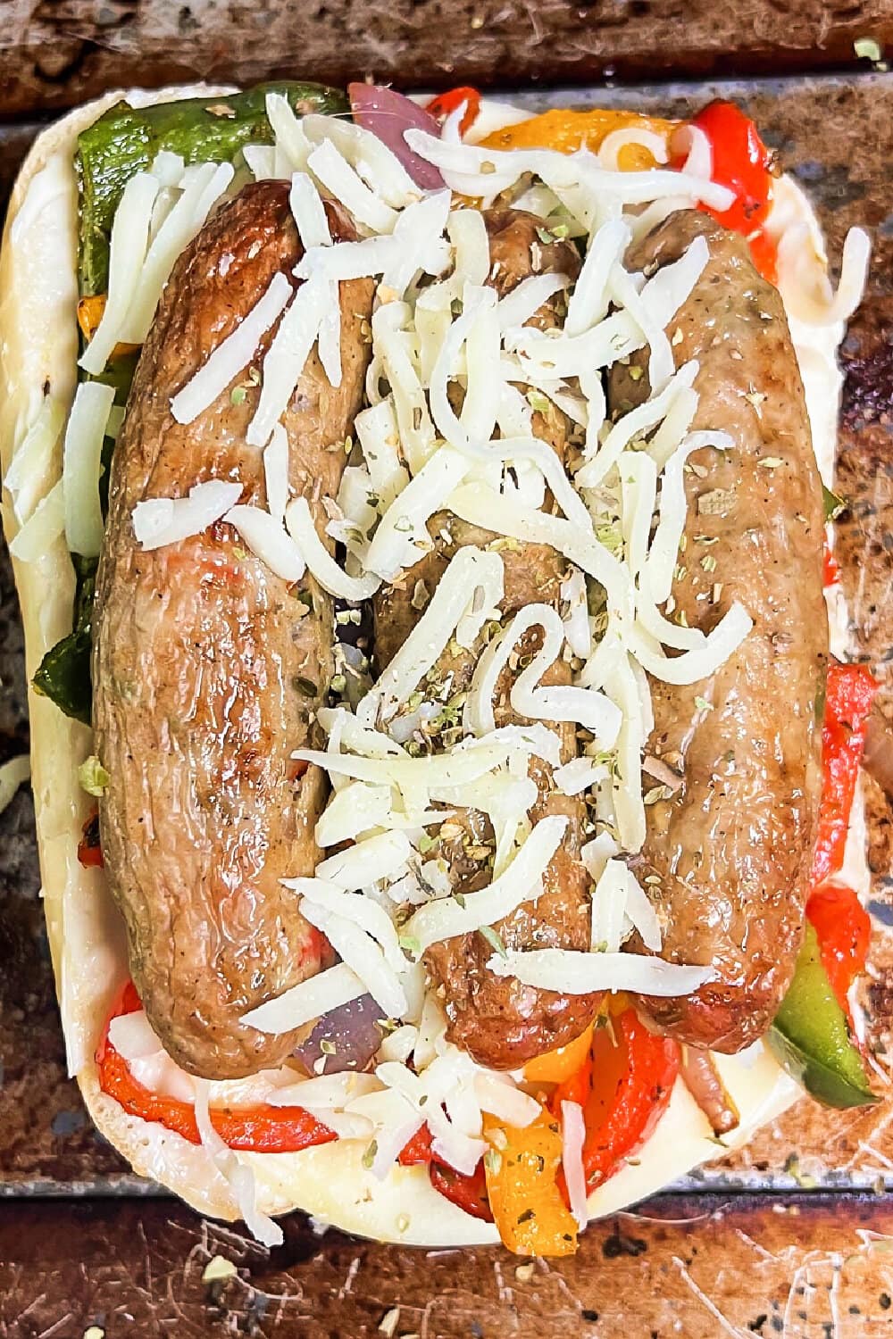 An Air Fryer Loaded Chicken Sausage Melt topped with shredded cheese. 