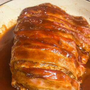 Saucy Bacon Pork Loin Roast that is ready to slice.