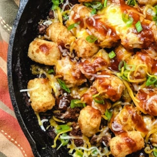 Shredded Beef Tater Tot Casserole in a cast iron skillet.