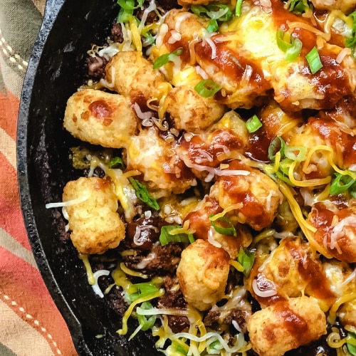 Shredded Beef Tater Tot Casserole in a cast iron skillet.